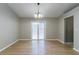 Open dining area with sliding door, chandelier lighting, and stylish flooring at 2654 Laurel View Dr, Snellville, GA 30039