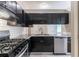 Contemporary kitchen showcasing stainless steel appliances, white subway tile backsplash, and dark cabinets at 2654 Laurel View Dr, Snellville, GA 30039