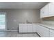 Basement kitchenette area featuring countertops and storage with a door to the outside at 2654 Laurel View Dr, Snellville, GA 30039