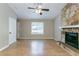 Bright living room showcasing a brick fireplace, large windows, and updated flooring at 2654 Laurel View Dr, Snellville, GA 30039