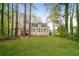 Home backyard with large trees, green grass, and view of house at 2799 Lake Jodeco Rd, Jonesboro, GA 30236