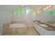 Bright bathroom featuring a soaking tub, double vanity, and large windows at 2799 Lake Jodeco Rd, Jonesboro, GA 30236