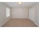 Empty bedroom with neutral carpet, walls, and a large window at 2799 Lake Jodeco Rd, Jonesboro, GA 30236