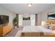 Staged primary bedroom with natural wood furniture and lots of natural light at 2799 Lake Jodeco Rd, Jonesboro, GA 30236