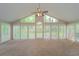 Bright sun room with large windows offering scenic views, and vaulted ceiling at 2799 Lake Jodeco Rd, Jonesboro, GA 30236