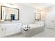 Bathroom with double vanity, soaking tub, tile surround, and contemporary fixtures at 3900 Danube Ln, Atlanta, GA 30339
