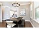 Dining room with modern chandelier, hardwood floors, and view to the kitchen at 3900 Danube Ln, Atlanta, GA 30339