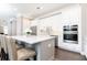 Modern kitchen featuring stainless steel appliances, a center island, and white cabinetry at 3900 Danube Ln, Atlanta, GA 30339