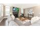 Cozy living room with a fireplace, large windows, and comfortable gray sofa at 3900 Danube Ln, Atlanta, GA 30339