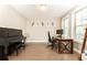 Home office with piano, large windows, modern decor, and ample workspace at 3900 Danube Ln, Atlanta, GA 30339