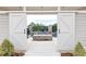 Inviting outdoor patio with a fire pit, seen through sliding barn doors, perfect for relaxation at 3900 Danube Ln, Atlanta, GA 30339