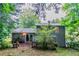 Backyard with a wooden deck, bench seating, and a view of the home's exterior at 4766 White Oak Path, Stone Mountain, GA 30088