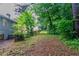 View of a spacious backyard surrounded by lush greenery, offering privacy and a peaceful outdoor space at 4766 White Oak Path, Stone Mountain, GA 30088