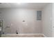 Unfinished basement space showing electrical panel, water connections, and bare walls at 4766 White Oak Path, Stone Mountain, GA 30088