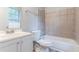 Clean bathroom with white vanity, toilet, and tiled shower-tub combination offers a functional design at 4766 White Oak Path, Stone Mountain, GA 30088