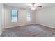 A cozy carpeted bedroom illuminated by natural light, offering a blank canvas for personalization at 4766 White Oak Path, Stone Mountain, GA 30088