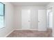 Bedroom featuring neutral walls, plush carpet, and doors for closet and bathroom at 4766 White Oak Path, Stone Mountain, GA 30088