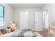 Bright bedroom featuring neutral walls, plush carpet, and a comfortable bed with stylish bedding at 4766 White Oak Path, Stone Mountain, GA 30088