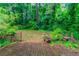 Wooden deck with built in benches and surrounding trees that creates a private setting at 4766 White Oak Path, Stone Mountain, GA 30088