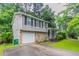 A split-level home showcasing a stone facade, attached garage, and well-maintained landscaping at 4766 White Oak Path, Stone Mountain, GA 30088