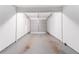 Empty garage with white walls and a closed gray garage door, ready for parking or storage at 4766 White Oak Path, Stone Mountain, GA 30088