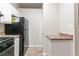 The kitchen featuring black appliances and neutral countertops, offers practicality and style at 4766 White Oak Path, Stone Mountain, GA 30088