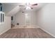 An empty room with new carpet, neutral paint, and access to the kitchen area and staircase at 4766 White Oak Path, Stone Mountain, GA 30088