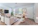Bright living room featuring modern furniture, a striped rug, and ample natural light at 4766 White Oak Path, Stone Mountain, GA 30088