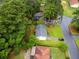 Overhead shot showing property, lush trees, neighborhood, and street; the house has gray roof at 6535 Buckhurst Trl, Atlanta, GA 30349