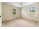 Bright bedroom with neutral walls, carpet flooring, and two windows for natural light at 6535 Buckhurst Trl, Atlanta, GA 30349