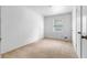 Simple bedroom with carpeted floors, a window, and closet at 6535 Buckhurst Trl, Atlanta, GA 30349
