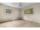Spacious bedroom with two windows and neutral-toned walls and carpet flooring at 6535 Buckhurst Trl, Atlanta, GA 30349