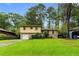 Two-story home with a well-manicured lawn and lush trees at 6535 Buckhurst Trl, Atlanta, GA 30349
