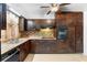 Kitchen with tile backsplash, stainless steel sink, range, and wooden cabinets at 6535 Buckhurst Trl, Atlanta, GA 30349
