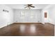 Bright living room with hardwood floors, neutral walls, ceiling fan, and windows bringing in natural light at 6535 Buckhurst Trl, Atlanta, GA 30349