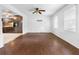 Open-concept living room with dark hardwood flooring and views of the adjacent kitchen at 6535 Buckhurst Trl, Atlanta, GA 30349