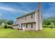 Exterior backyard view of a two-story siding home with a chimney and grassy yard at 6683 Princeton Park Ct, Lithonia, GA 30058