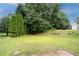 Lush backyard featuring green lawn and mature trees, offering a serene and private outdoor space at 6683 Princeton Park Ct, Lithonia, GA 30058