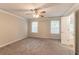 Bedroom featuring neutral walls, carpeted floor, ceiling fan, and a bright window at 6683 Princeton Park Ct, Lithonia, GA 30058