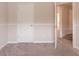 Cozy bedroom featuring neutral walls, carpeted floor, and an open door at 6683 Princeton Park Ct, Lithonia, GA 30058