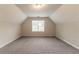 Spacious bonus room with gray carpet and dormer window at 6683 Princeton Park Ct, Lithonia, GA 30058