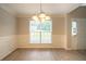 Light and airy dining room features modern lighting and updated flooring at 6683 Princeton Park Ct, Lithonia, GA 30058