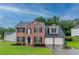 Traditional two-story brick home with a two-car garage, black shutters and landscaped front yard at 6683 Princeton Park Ct, Lithonia, GA 30058