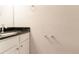 Clean half bathroom featuring a sink with a black granite countertop at 6683 Princeton Park Ct, Lithonia, GA 30058