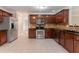 This kitchen features stainless steel appliances, granite countertops and rich wood cabinets at 6683 Princeton Park Ct, Lithonia, GA 30058