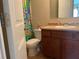 Bathroom with a functional vanity, toilet, and shower curtain, showcasing cleanliness and practical design at 805 Pleasant Hill Nw Rd # 53, Lilburn, GA 30047