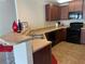 Kitchen with dark cabinets, black appliances, and a breakfast bar overlooking the sink at 805 Pleasant Hill Nw Rd # 53, Lilburn, GA 30047