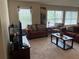 Comfortable living room featuring two sofas, an armchair, and large windows for natural light at 805 Pleasant Hill Nw Rd # 53, Lilburn, GA 30047