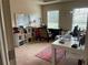 Bright home office with large windows, white desk, and functional storage solutions at 805 Pleasant Hill Nw Rd # 53, Lilburn, GA 30047