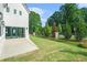 Large backyard with manicured lawn, patio, and fence is perfect for relaxing or entertaining at 115 Thome Dr, Alpharetta, GA 30022